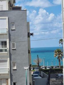 a view of the ocean from a building at Sweet apartment in Netanya
