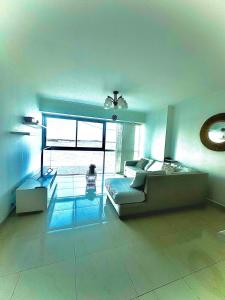 a large living room with a couch and a window at River view 6-04 in Guayaquil