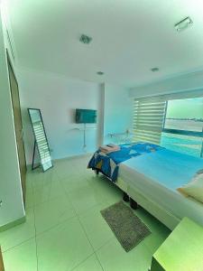 a bedroom with a bed with a view of the ocean at River view 6-04 in Guayaquil