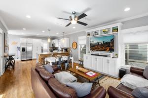 a living room with a couch and a table at HOT TUB Sauna Cold Plunge Nashville Party Place in Nashville