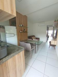 a kitchen with a table and a dining room at flats Monte Castelo Gravatá -PE in Sairé