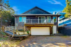 a house with a garage and a balcony at Frannie's Beachfront in Seaside