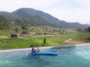 a person is riding on a raft in the water at BAHAR rest in Panundaan