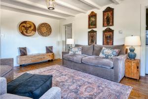 a living room with a couch and a table at Tesuque Outpost Casita E Best views in Santa Fe in Santa Fe