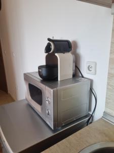 a printer sitting on top of a microwave at Ski & View Pamporovo Apartment in Smolyan +9 photos