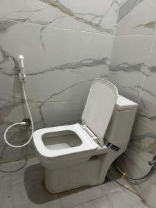 a bathroom with a white toilet in a room at Nature Homes 2 bhk independent Flat in Dehradun +15 photos