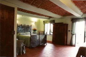 a bedroom with a bed in a room with windows at Agriturismo Dei Magi in Priocca