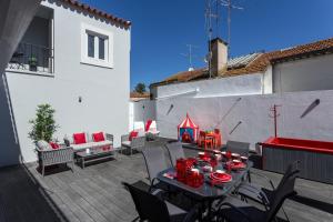 a patio with a table and chairs and a playground at Akicity Santarém Rock in Santarém