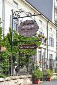 a sign in front of a building with a fence at Villa Cavalleri in Gattinara +22 photos