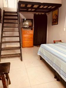 a bedroom with a ladder and a bed and a dresser at Mirador de Rosales in Dosquebradas +2 photos
