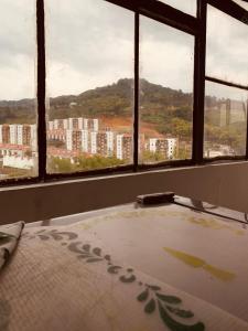 a room with windows with a view of a city at Mirador de Rosales in Dosquebradas