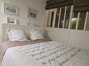 a bedroom with a bed with writing on it at Terrasse de Malissol in Vienne