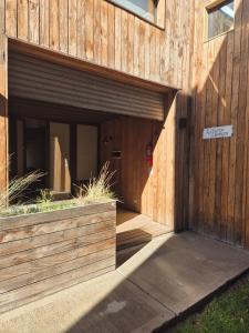 a wooden building with a large door on it at Galpon de Burgos - SalePatagonia in San Martín de los Andes +33 photos