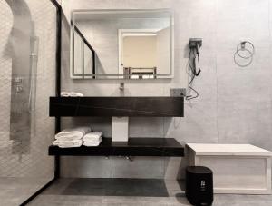a bathroom with a sink and a mirror at Oasis Breez - Family Room in Kudafari