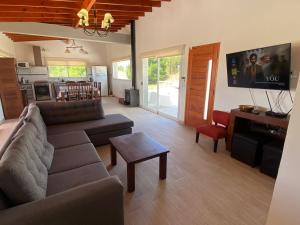 a living room with a couch and a table at Maura Del Mar casa de playa 4x4 in Mar Azul