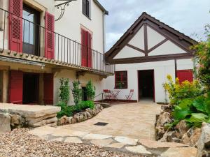 an exterior view of a house with red shutters at Gîte et studio Les Grands Crus in Morey-Saint-Denis +43 photos