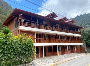 a building with a balcony on the side of it at The Lookout Hideaway in Baños