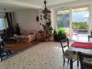 a living room with a table and a couch at Chez Mamo in Bescat