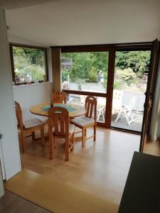 a dining room with a table and chairs and a patio at Ferienhaus Burgblick in Bad Münstereifel