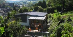 a small house with a roof on a hill at Ferienhaus Burgblick in Bad Münstereifel +12 photos