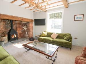 a living room with a couch and a fireplace at Daniels Farmhouse in Worcester