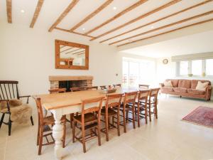 a dining room with a wooden table and chairs at Daniels Farmhouse in Worcester