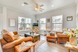 a living room with leather furniture and windows at 1 Mi to Beach Access Home with Porch in Fort Myers! in Fort Myers
