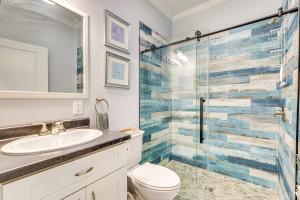 a bathroom with a toilet and a glass shower at 1 Mi to Beach Access Home with Porch in Fort Myers! in Fort Myers +16 photos