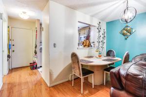 a dining room with a table and chairs at 3 Mi to Dtwn New Haven Colorful Condo with Yard! in West Haven