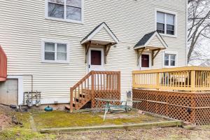 a house with a wooden deck in front of it at 3 Mi to Dtwn New Haven Colorful Condo with Yard! in West Haven