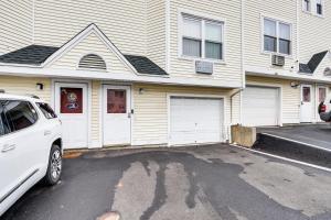 a white car parked in front of a house at 3 Mi to Dtwn New Haven Colorful Condo with Yard! in West Haven