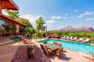 a patio with a table and chairs and a pool at Saddle Rock Ranch B&B at West Sedona in Sedona
