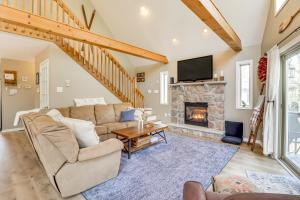 a living room with a couch and a fireplace at Walk to Lake Harmony Family Retreat with Decks! in Albrightsville