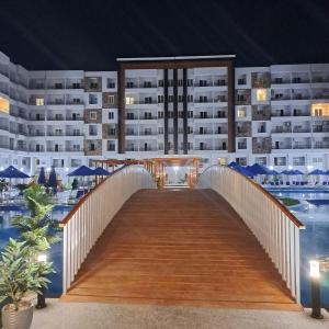 a bridge over a pool in front of a building at Hurghada Holiday Studio with Beach in Hurghada