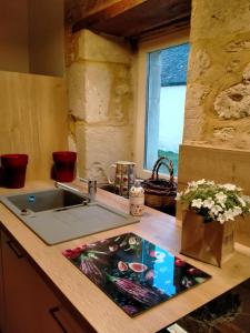 a kitchen counter with a sink and a window at Chez les sœurs in Igé +35 photos
