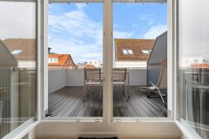 a view from the balcony of a apartment with large windows at Haus Klaus Lucky in Norderney