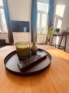 a candle and a remote control on a table at FeWo Nordseebrise in Wilhelmshaven +4 photos