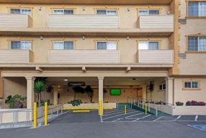 an empty parking lot in front of a building at University Inn & Suites Berkeley in Berkeley