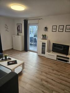 a living room with a couch and a flat screen tv at Hakans Moselblick Ferienwohnung in Treis-Karden
