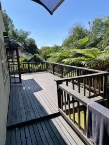 a wooden deck with a bench on top of it at Botterblom Hide-Away in Sabie