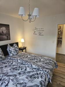 a bedroom with a bed with a black and white comforter at Hakans Moselblick Ferienwohnung in Treis-Karden