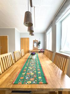 a dining room table with chairs and a rug at Landhaus Stolper Wohnung 3 in Herzberg am Harz +24 photos