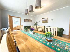 a dining room with a wooden table with plants on it at Landhaus Stolper Wohnung 3 in Herzberg am Harz