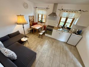 a living room with a couch and a kitchen at Ferienwohnung Jahnel in Waging am See