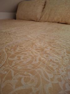 a close up of a bed with a pattern on it at VILLA GOLF Crystal Drop Apartment in Rogaška Slatina +35 photos
