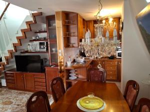 a dining room with a table and a chandelier at VILLA GOLF Crystal Drop Apartment in Rogaška Slatina