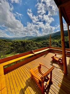 a wooden deck with two benches on top of it at Cabana Bariloche - Busch Camping in Rancho Queimado +45 photos