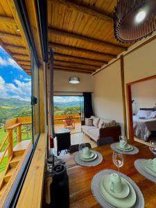 a room with a view of a living room at Cabana Bariloche - Busch Camping in Rancho Queimado