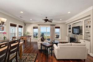 a living room with a ceiling fan and a living room at CSC3R - Tres Bien in Kill Devil Hills