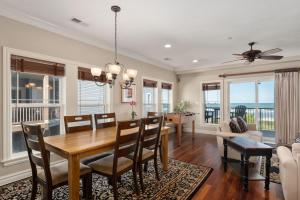 a dining room and living room with a table and chairs at CSC3R - Tres Bien in Kill Devil Hills